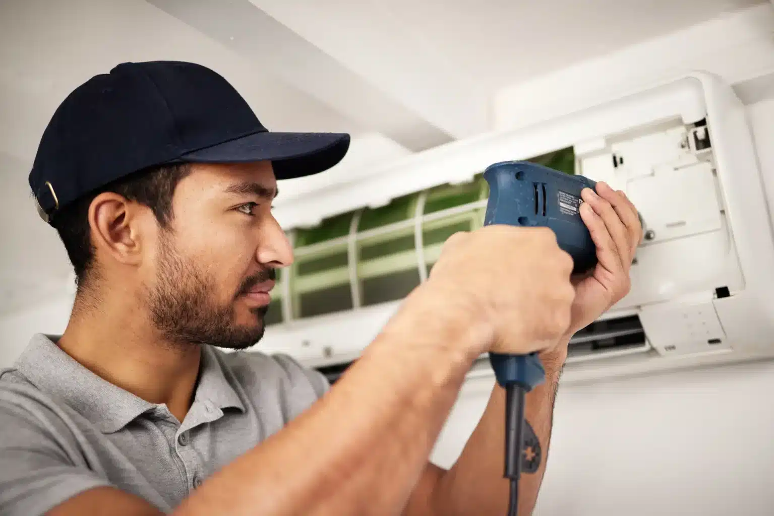 ac repair on a ductless hvac unit by technician