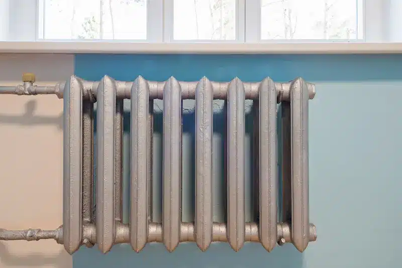 a cast iron radiator on a wall inside home