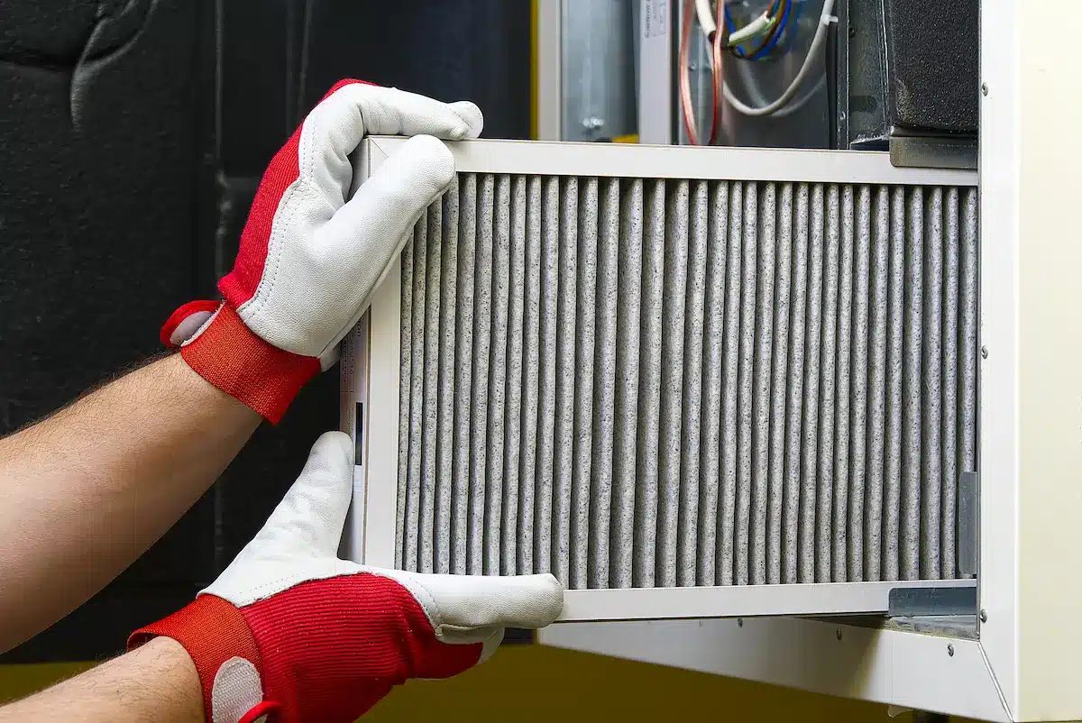 HVAC technician changing hvac filter