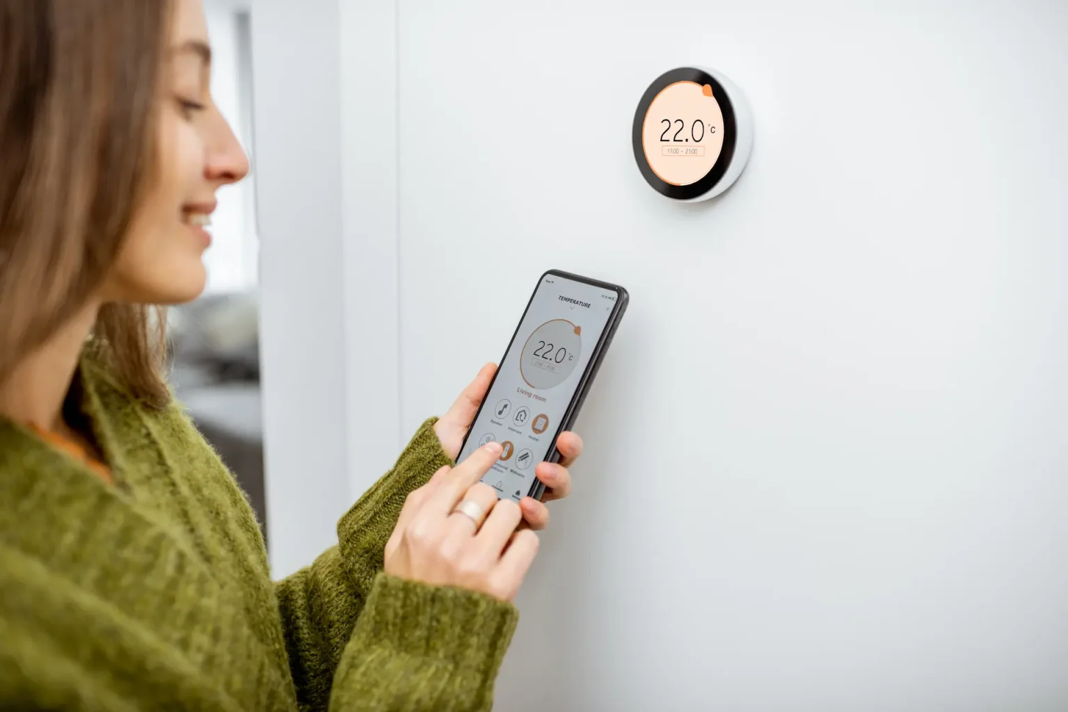 woman setting up thermostat after new furnace installation