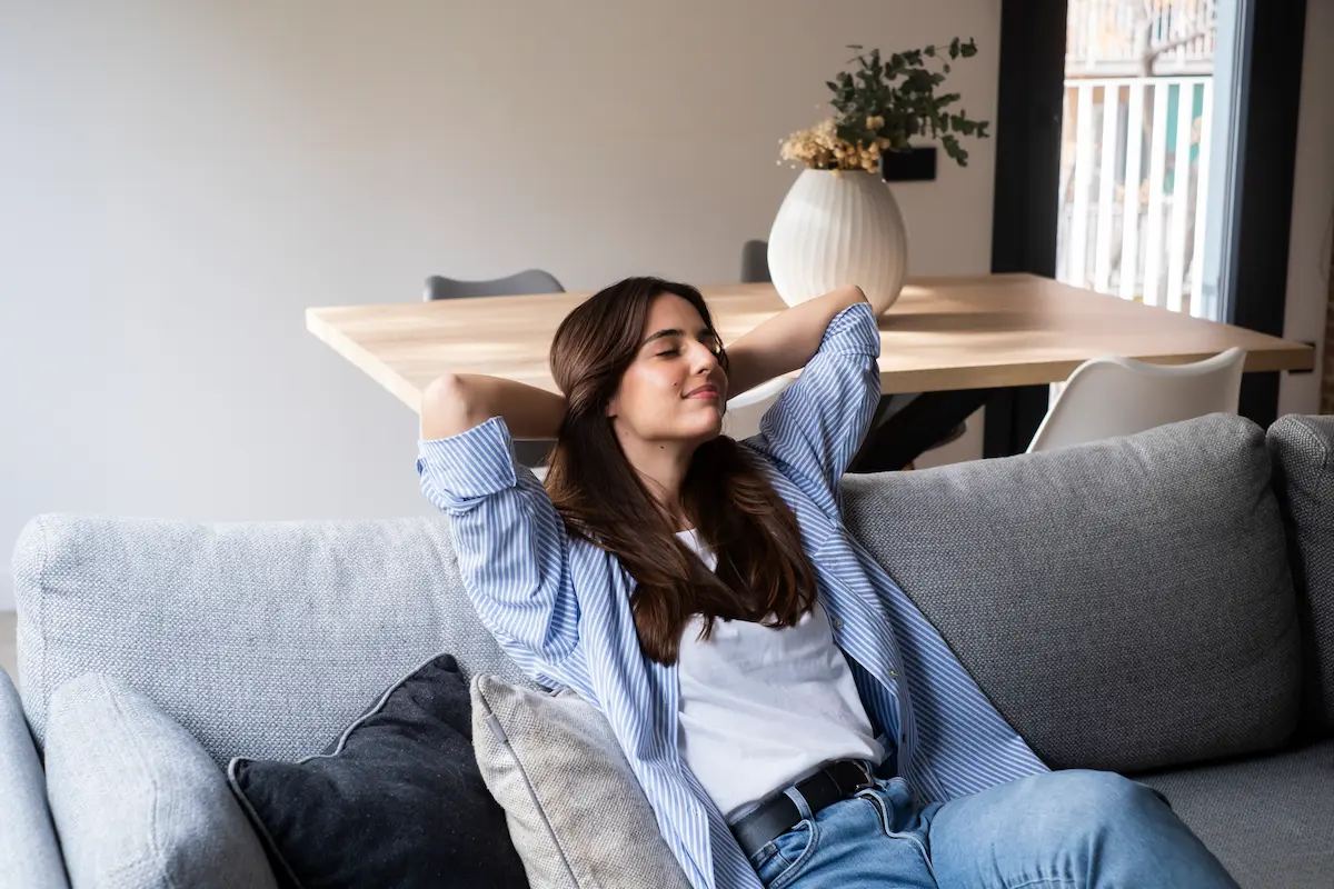 woman on couch relaxing and enjoying indoor clean air services