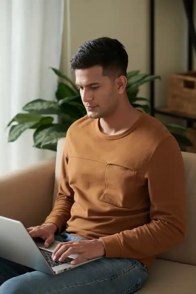 man getting a quote on laptop at home